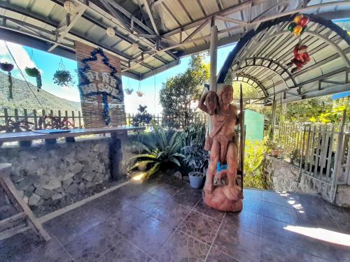 a statue of a woman sitting on a surfboard at Banaue Pink Eco hostel in Banaue