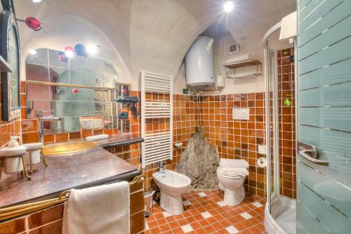 a bathroom with a toilet and a sink at Apartments In The Heart of Medieval Village - Happy Rentals in Apricale