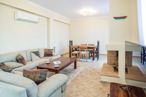a living room with a couch and a table at Villa Alba Minies in Minia