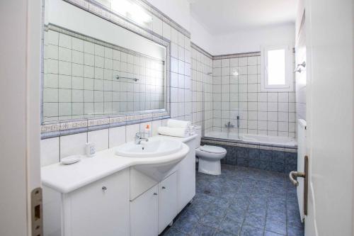 a white bathroom with a sink and a toilet at Villa Alba Minies in Minia