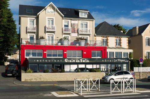 a red double decker bus in front of a building at La Maison Régent & spa face à la mer in Pornichet