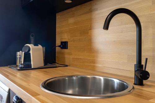 a kitchen sink with a faucet on a counter at Rawsons shack Beachfront unit suits single or couple in Henley Beach South