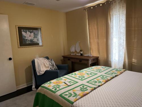 a bedroom with a bed and a chair and a table at Park View East in Lakeland