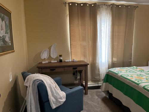 a bedroom with a bed and a chair and a table at Park View East in Lakeland