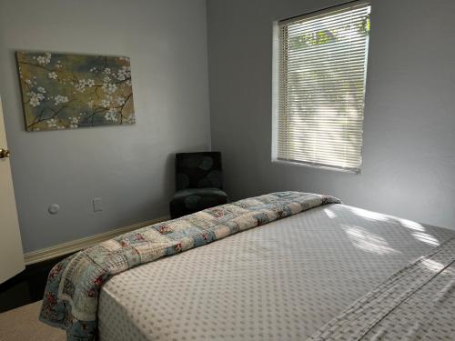 a bedroom with a bed and a chair and a window at Park View East in Lakeland