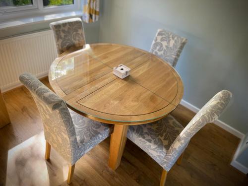 a wooden table and two chairs with a wooden table at 3-bedroom bungalow, central Ambleside with parking in Ambleside