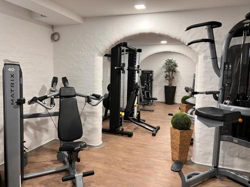 a gym with several tread machines in a room at Hotel PrimaVera parco in Fürth