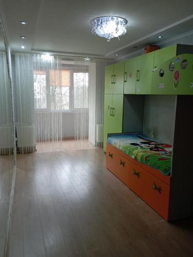 a bedroom with a bed in a room with green cabinets at Apartament cu 2 odai in chirie or.Soroca in Soroca