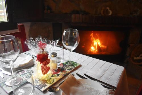 un tavolo con un piatto di cibo e bicchieri di vino di Casa KiSi Hotel, Rural Boutique Bed & Breakfast a Málaga