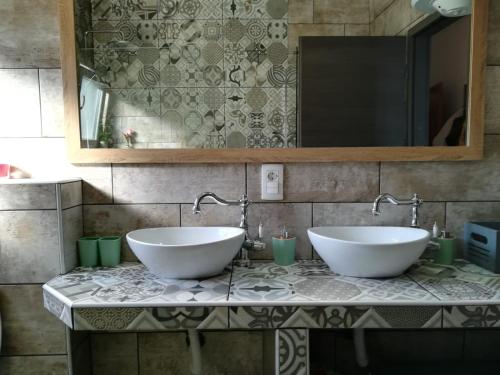 two sinks on a marble counter in a bathroom at Apartmani Radić Rg in Rogoznica