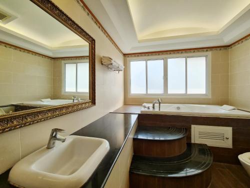 a bathroom with a sink and a mirror at Phu Pha Phung Resort in Suan Phung