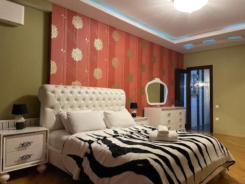 a bedroom with a bed with a zebra print wall at Park Azure Residence in Baku