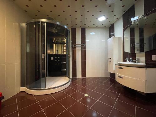 a large bathroom with a shower and a sink at Park Azure Residence in Baku