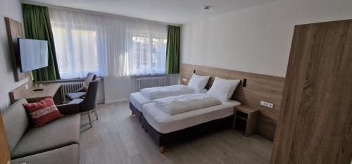 Postel nebo postele na pokoji v ubytování Hotel Ladage