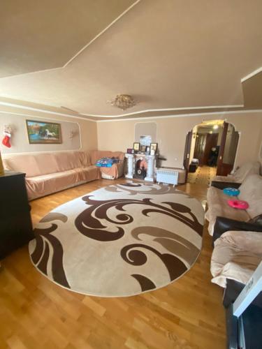 a living room with a rug on the floor at Просторі та комфортні апартаменти «Д.І.М.» in Kamianets-Podilskyi