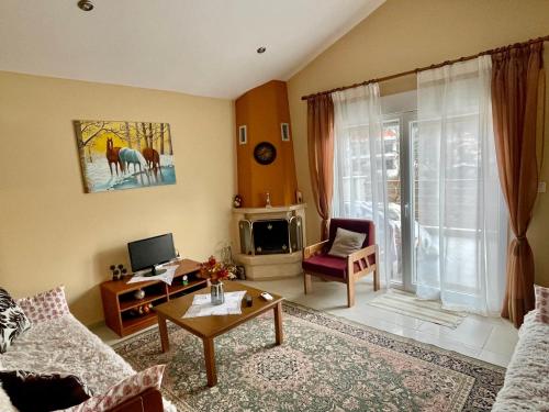 a living room with a couch and a tv at Hilltop Lodge Orma in Órma