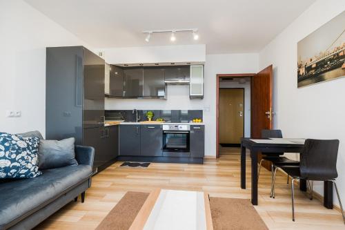 a living room with a couch and a table at ShortStayPoland Grodkowska (B114) in Warsaw
