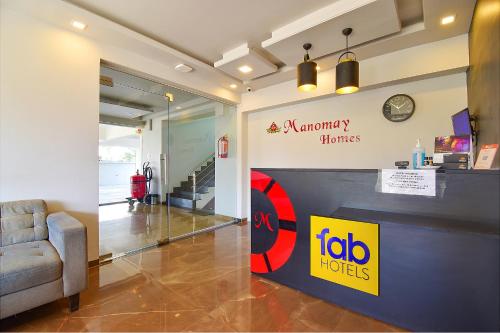 a lobby of a hotel with a waiting room with a clock at FabHotel Manomay Stays I- Nagpur Airport in Nagpur