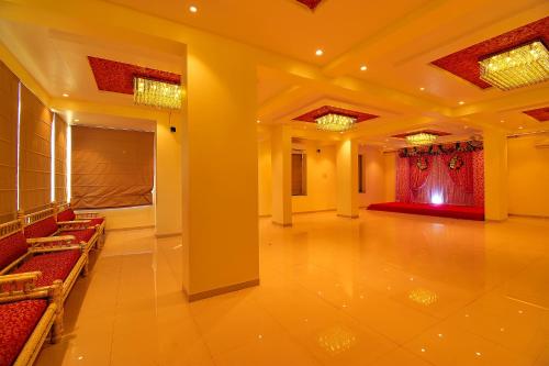 a large hall with a red curtain and a stage at FabHotel Manomay Homes - Nr Manish Nagar in Nagpur