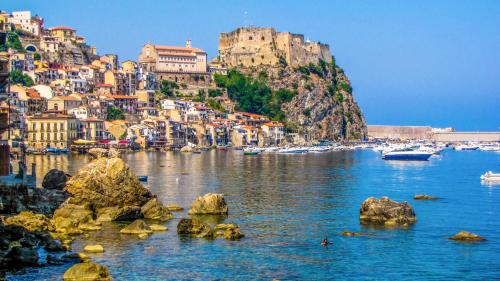 a view of a harbor with a town on a mountain at Altafiumara Resort & Spa in Villa San Giovanni