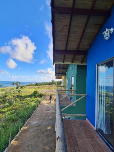 a porch of a house with a view of the ocean at Village as casinhas in Uruçuca