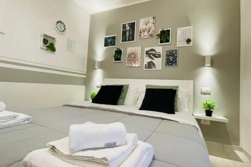 a bedroom with a bed with towels on it at Ca' Ross in Formigine