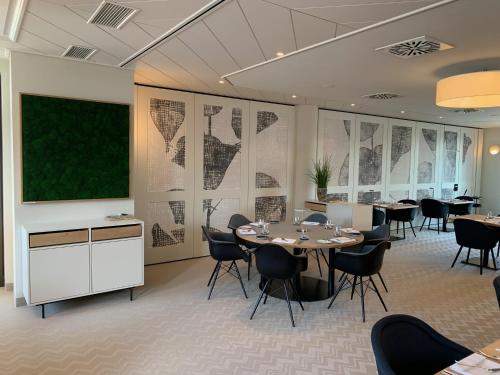 a conference room with tables and a large screen at Gasthof zum Bad in Langenau