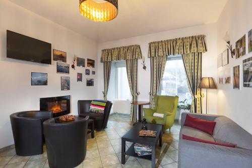 a living room with a couch and a fireplace at Augustus et Otto Hotel in Prague