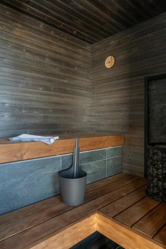 a sauna with a potted plant and a clock at Ski-Inn Kultakero in Pyhätunturi