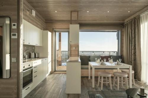 a kitchen and dining room with a table and chairs at Ski-Inn Kultakero in Pyhätunturi