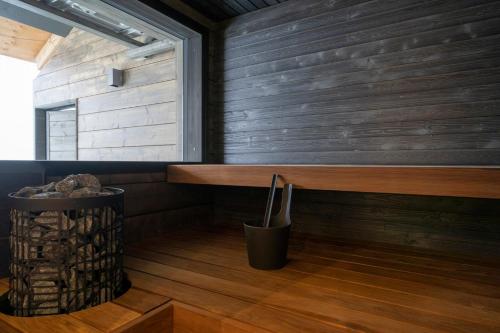 a room with a wooden wall with a bench and a window at Ski-Inn Kultakero in Pyhätunturi