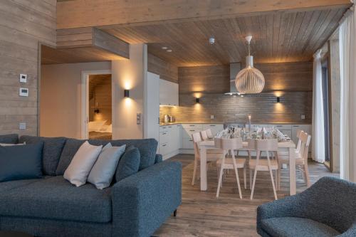 a living room with a couch and a dining room at Ski-Inn Kultakero in Pyhätunturi