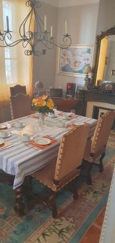 a dining room table with a blue and white table cloth at Maison Carrasserie in Limoux