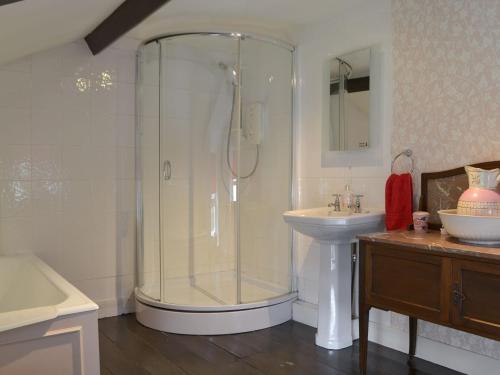 a bathroom with a shower and a sink at Gilmore House in Alston