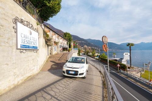 a white car parked on the side of a street at Residence Casa e Vela in Oggebbio