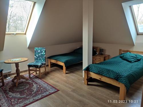 a bedroom with a bed and a table and a chair at Residence Park in Bielsko-Biała