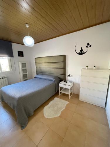 a bedroom with a bed and a crescent moon on the wall at Casa Amoedo in Redondela
