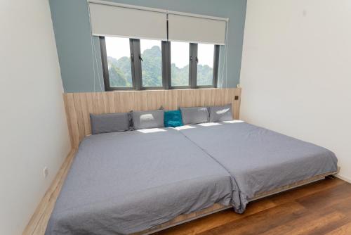 a bed in a bedroom with a large window at Ipoh Tambun Lost World Sunway Onsen Suites Lana 2R2B 8 paxs in Tambun