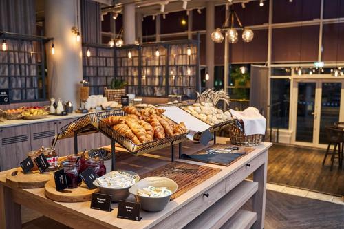 a buffet with bread and other foods on a table at Radisson Blu Latvija Conference & Spa Hotel, Riga in Rīga