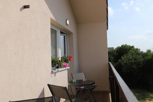 a balcony with a table and a window with a laptop at Rezidencia Podhájska in Podhájska