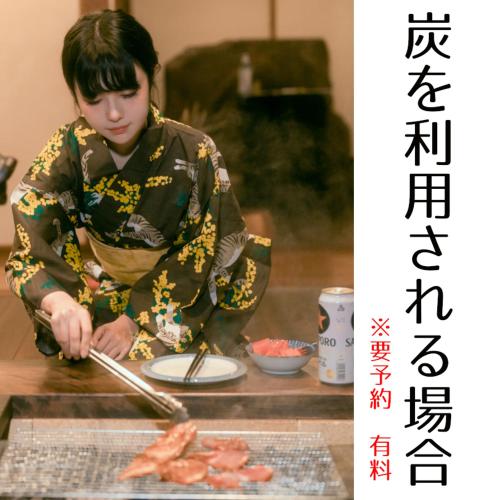 a woman preparing food on top of a table at Guesthouse Omoya--全個室--囲炉裏のぬくもりと共にグループの絆を深める古民家宿でゆっくりとした時間を-6名部屋-6名部屋-8名部屋--最大20名-ペット同伴可は一室のみ- in Matsuyama