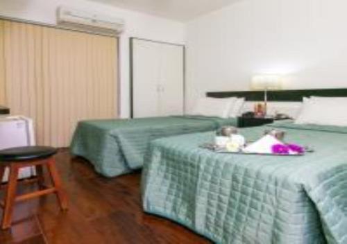 Ένα ή περισσότερα κρεβάτια σε δωμάτιο στο Hotel Minas Tower Leopoldina By Samba
