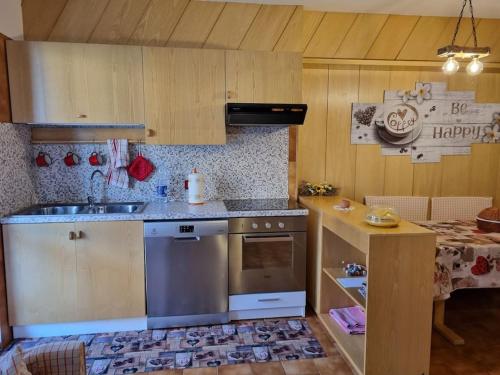 a kitchen with a sink and a stove top oven at Casetta Loretta in San Pietro