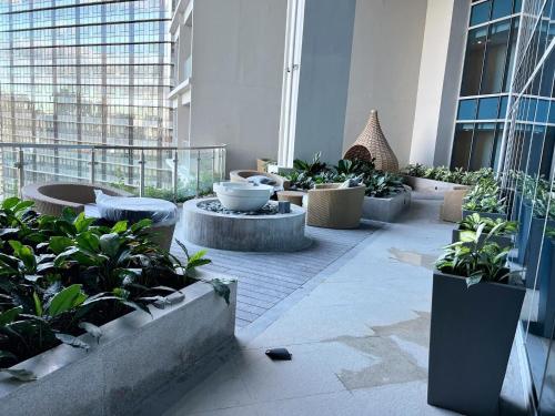 a building with a courtyard with potted plants at BGC, Uptown Parksuites Tower 2 in Manila