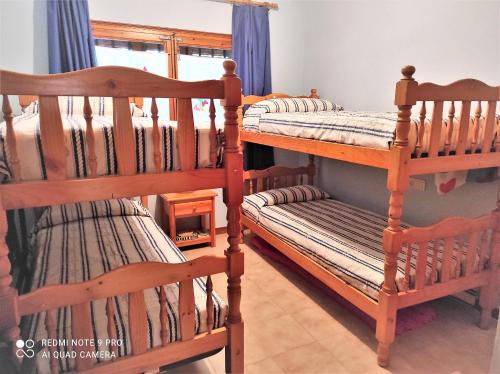 two bunk beds in a room with a window at Apartamento Country Club 605 in Pals