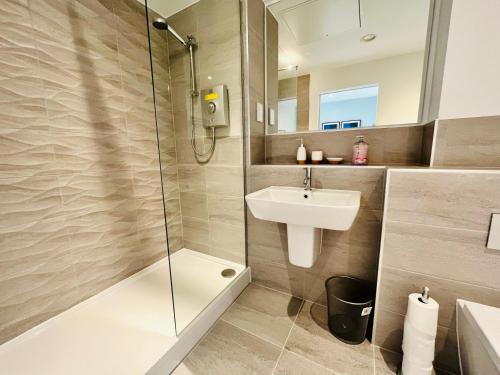 uma casa de banho com um chuveiro, um lavatório e um WC. em Spectacular Studio Apartment near to Old Trafford stadium em Manchester