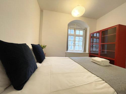 a bedroom with a large bed with a red cabinet at Westminster Apartment near River Thames in London