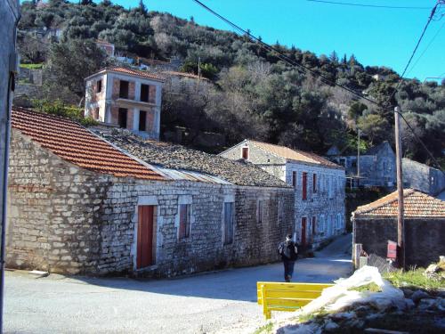 a person walking down a street next to buildings at Studio Fetsi in Kiónion