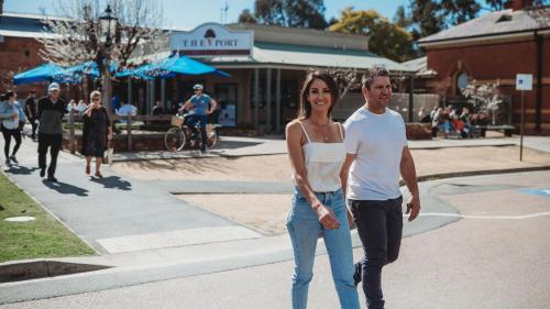 a man and a woman walking down a street at Bridges on Meninya Motel & Apartments in Moama