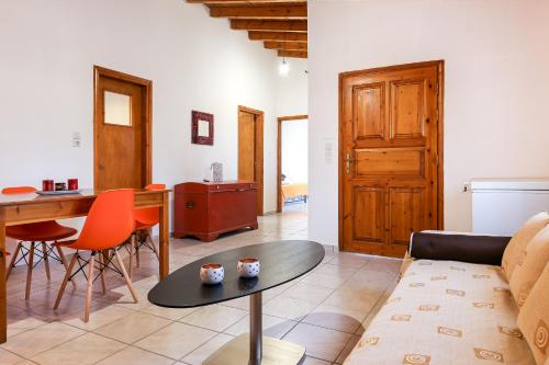 a living room with a couch and a table at Creta 2 bedrooms 6 persons village house in Vasilópoulon